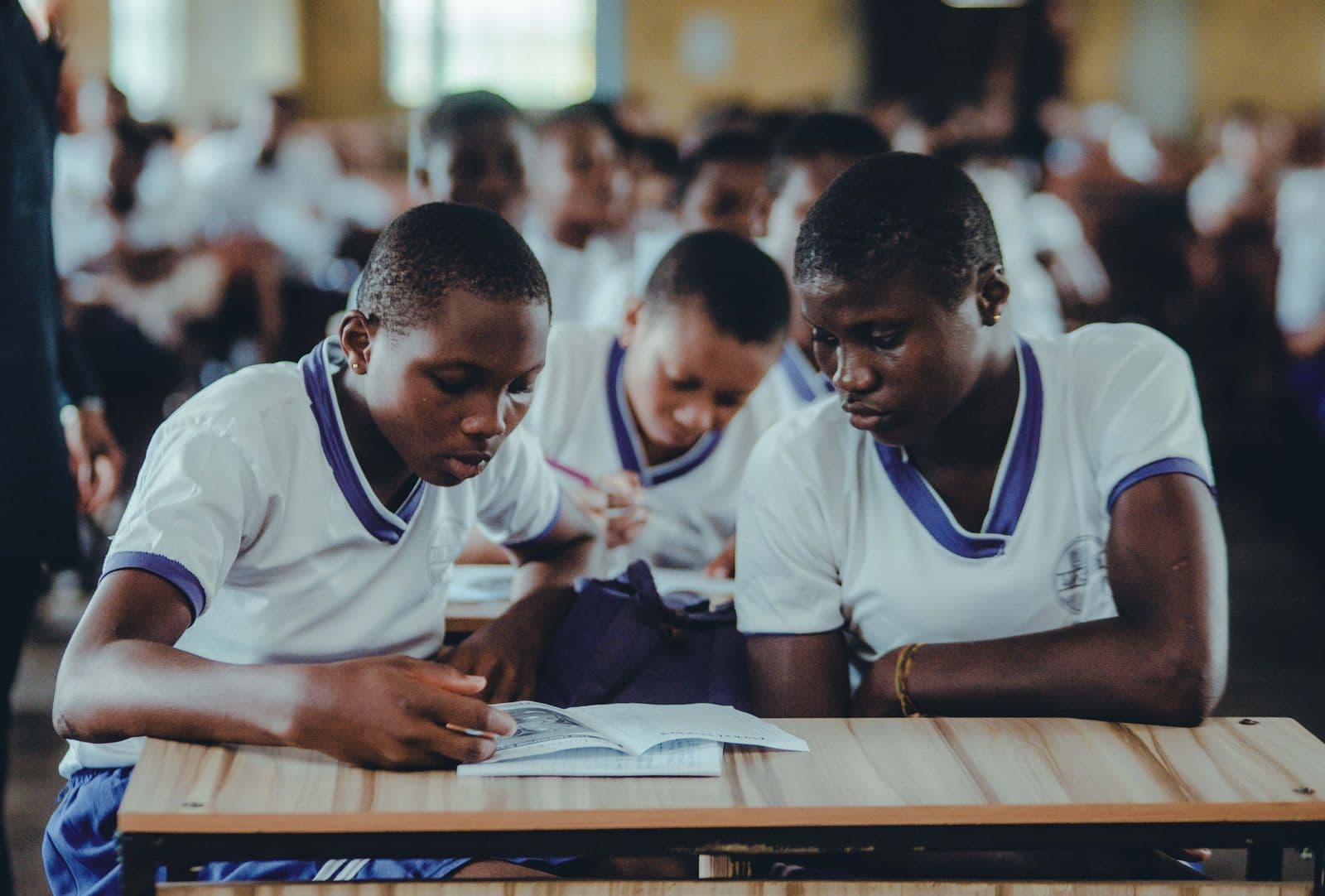 Junior secondary learners studying together at their desks