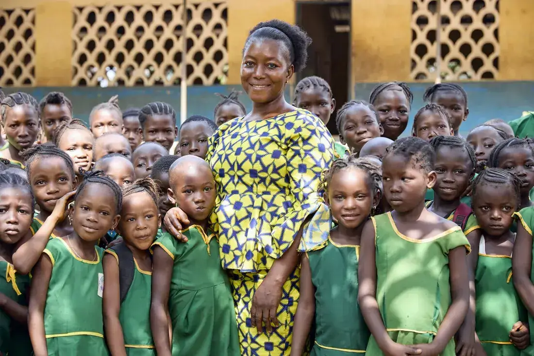 A teacher supporting schoolchildren with their work